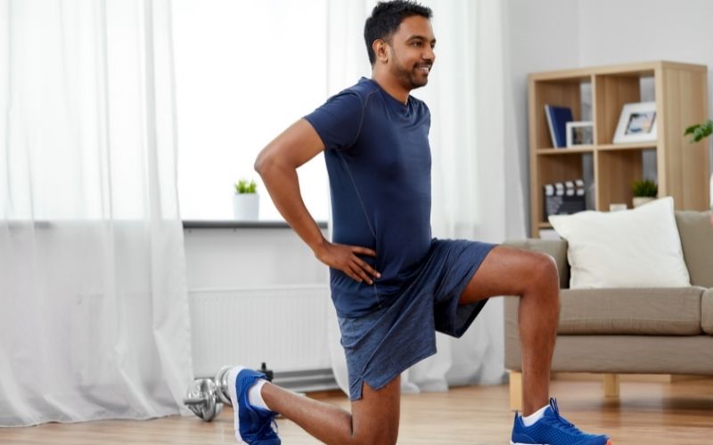 man doing lunges in home
